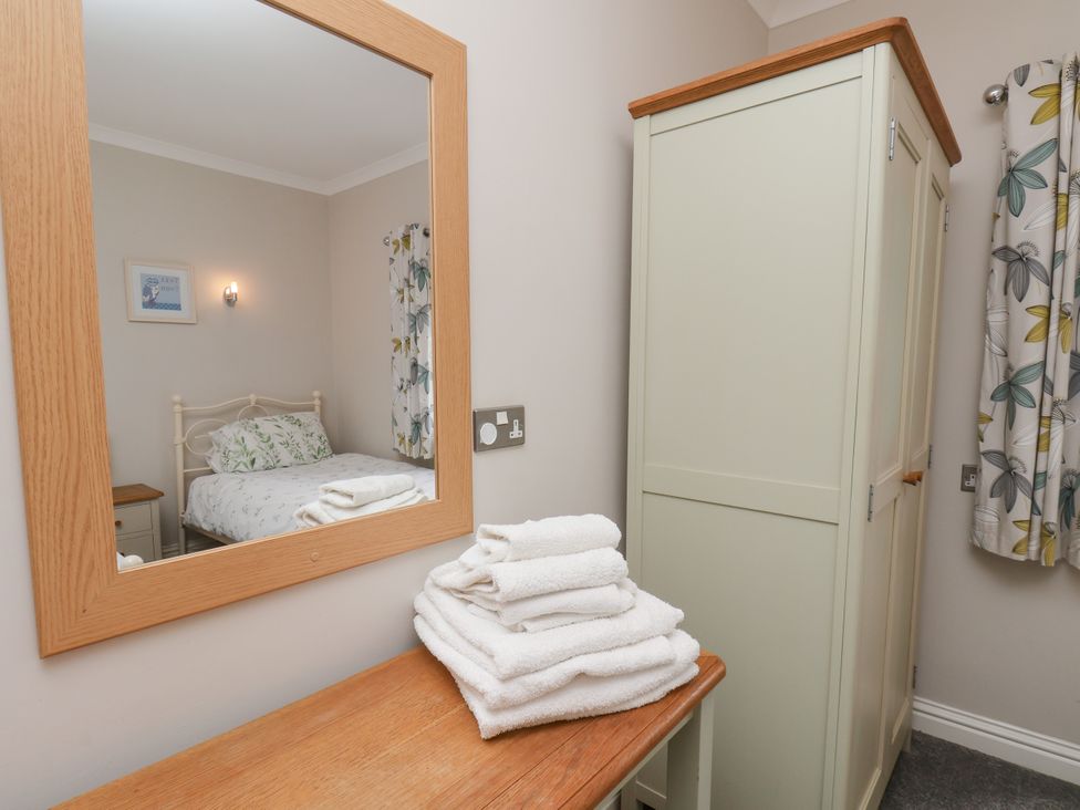 A bedroom with a bed and towels on a table at Beacon in Gerrick near Moorsholm