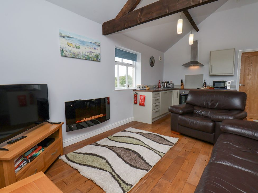 A living room with a television and sofa at Freeborough in Gerrick near Moorsholm