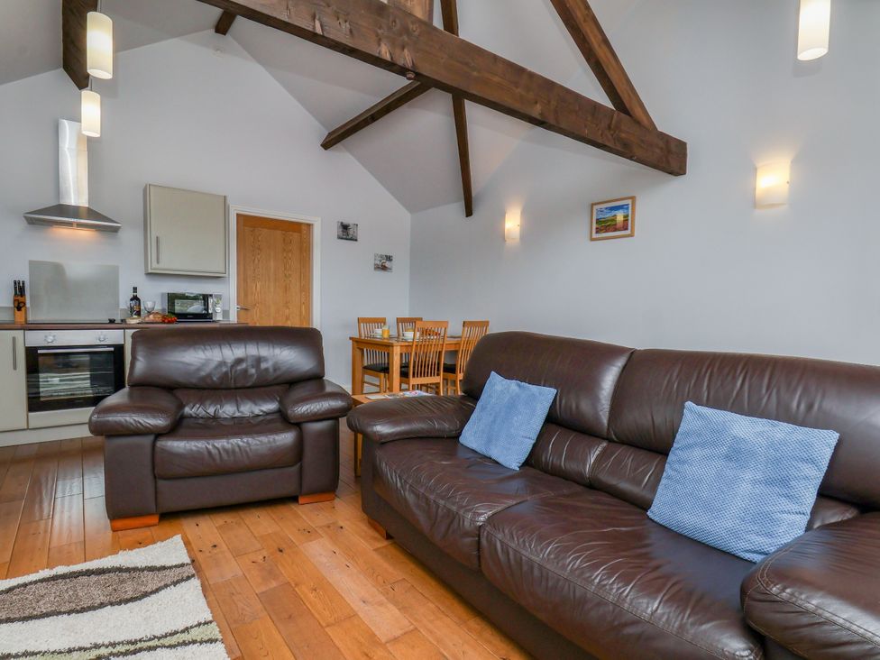 A living room with sofa and dining table at Freeborough Gerrick near Moorsholm