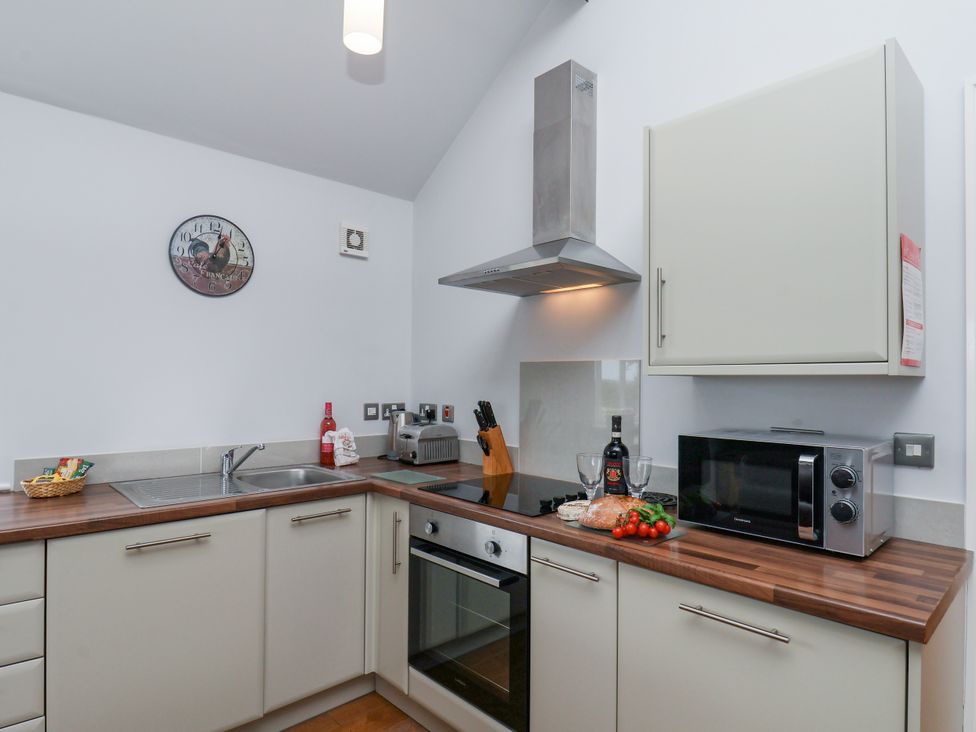 A kitchen with sink, oven, stove, and microwave at Freeborough, Gerrick near Moorsholm