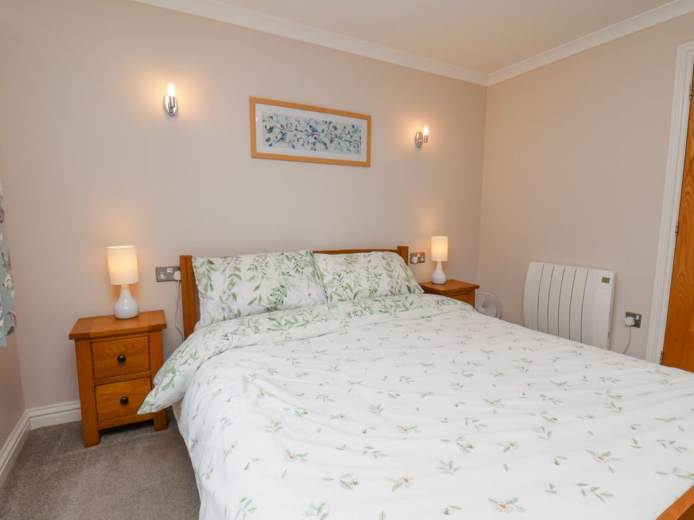 A bedroom with a bed and bedside tables at Freeborough in Gerrick near Moorsholm