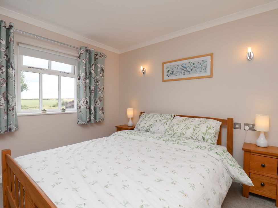 A bedroom with a bed and window at Freeborough in Gerrick near Moorsholm