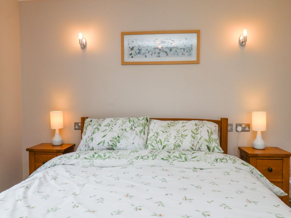 A bedroom with a bed and bedside tables at Freeborough Gerrick near Moorsholm