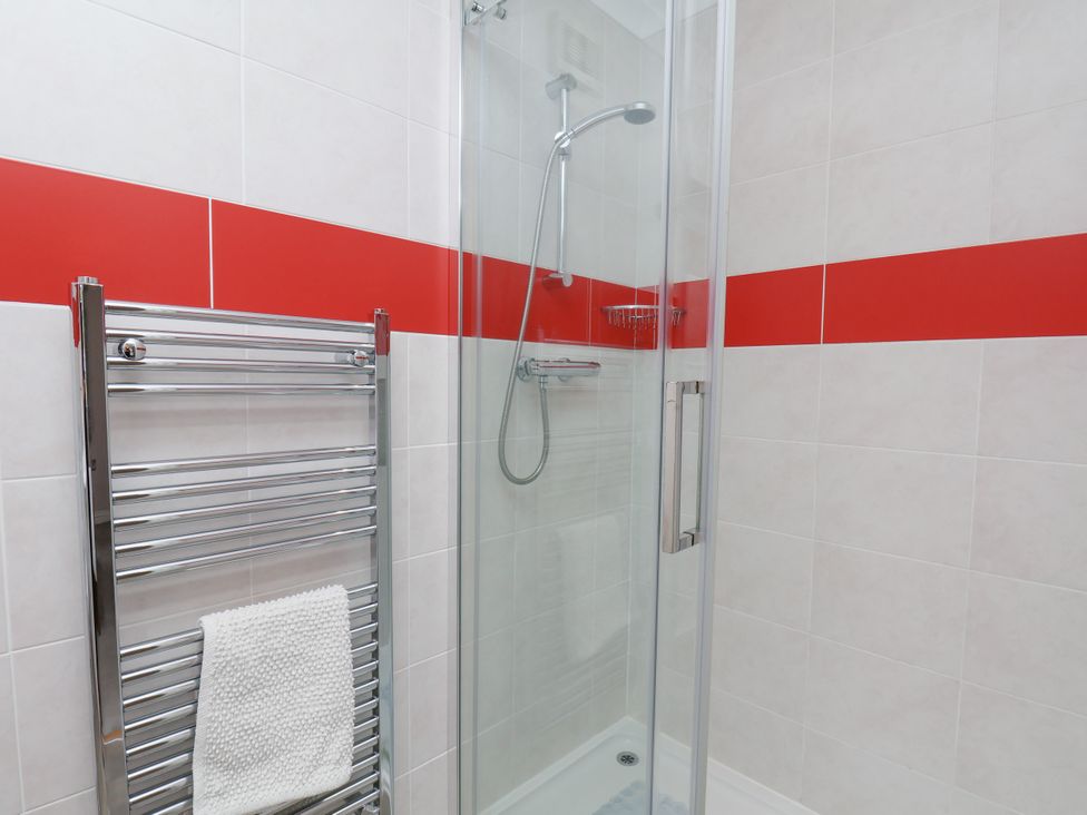 A bathroom with a shower and towel rail at Freeborough Gerrick near Moorsholm