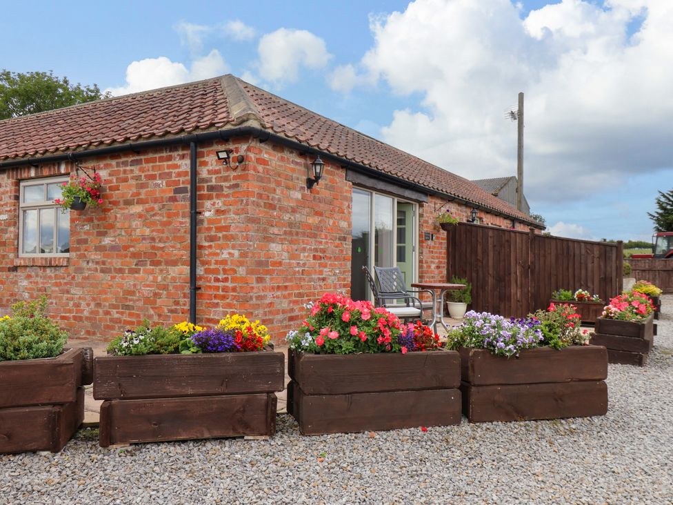 An outdoor area with flower pots and seating at Freeborough Gerrick near Moorsholm