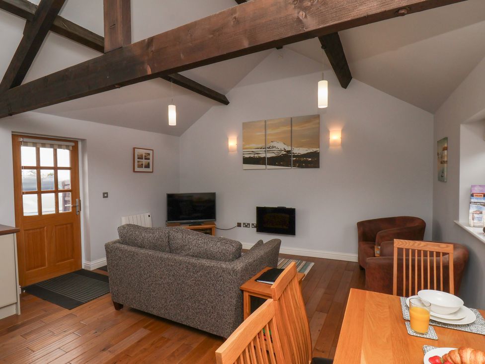 A living room with a sofa and dining area at Blakey in Gerrick near Moorsholm