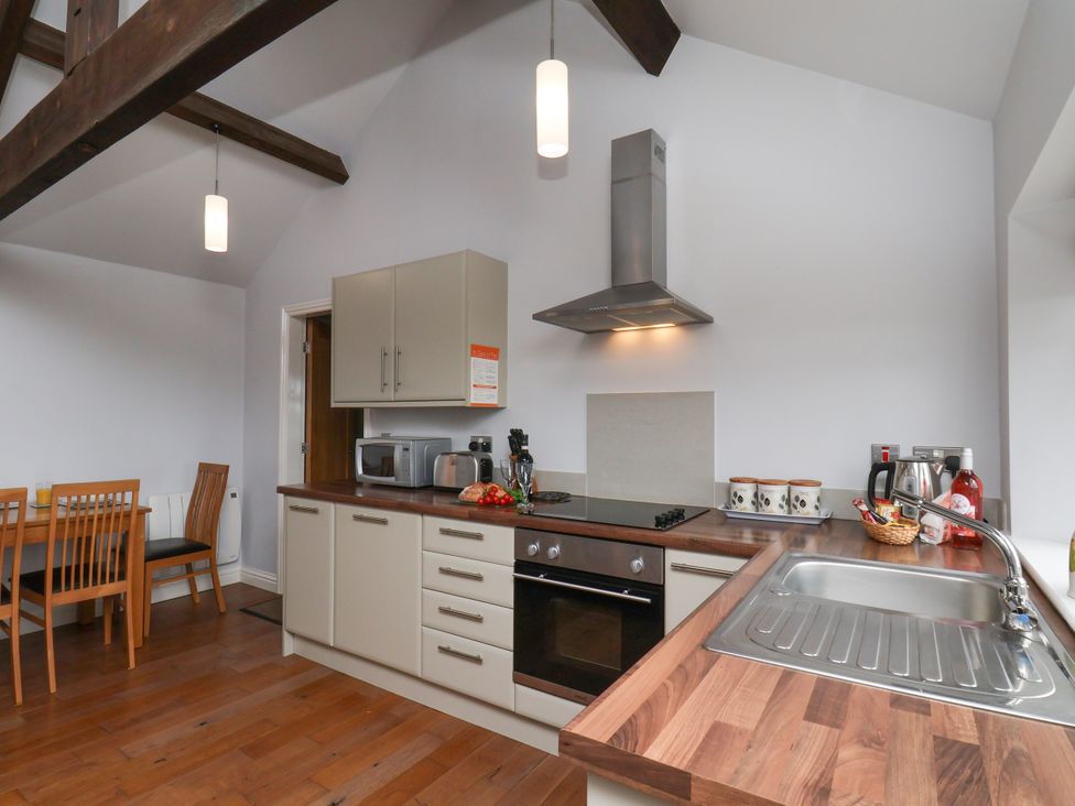 A kitchen with appliances and dining table at Blakey in Gerrick near Moorsholm