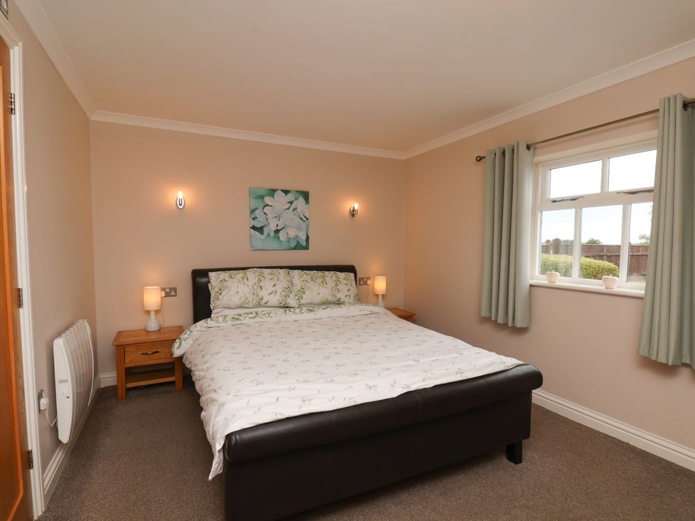 A bedroom with a bed and nightstand at Blakey Gerrick near Moorsholm
