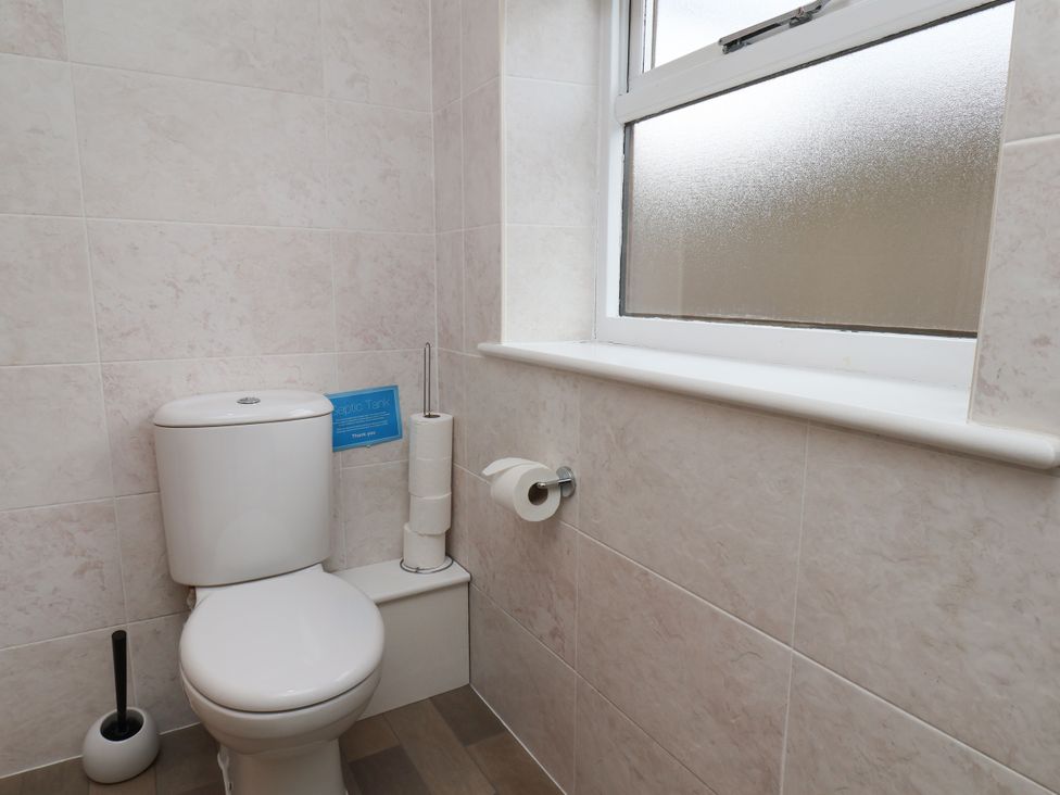 A bathroom with a toilet and window at Blakey Gerrick near Moorsholm
