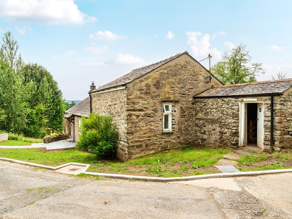 An outdoor area with a stone building and pathway at Dove Cottage at the Graythwaite Estate near Hawkshead