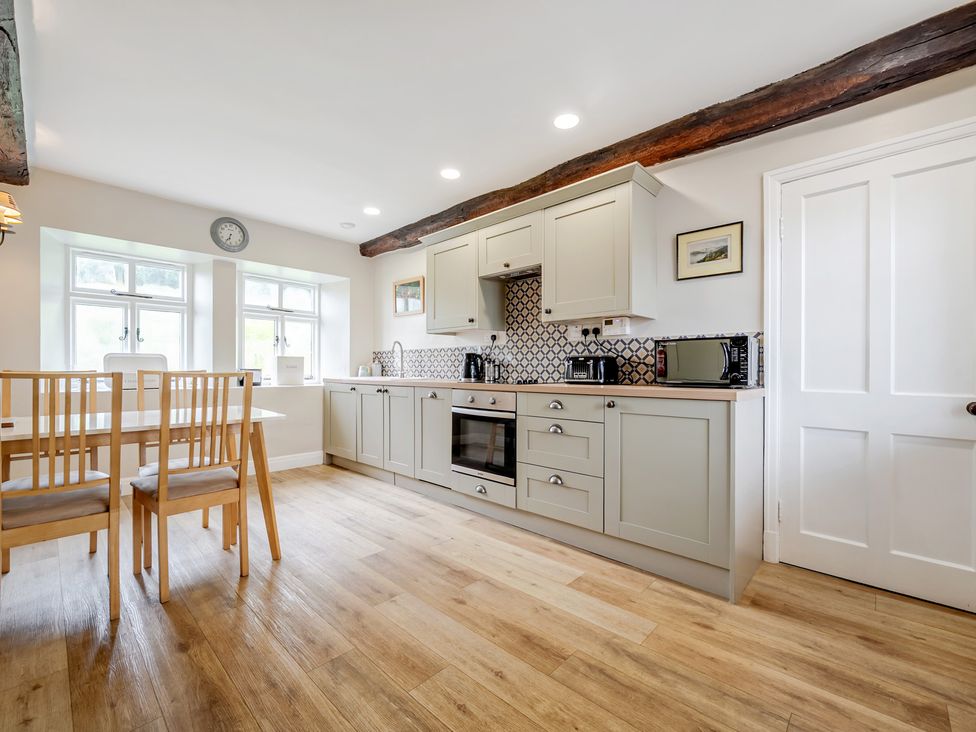 A kitchen with a table and chairs at Dove Cottage at the Graythwaite Estate near Hawkshead