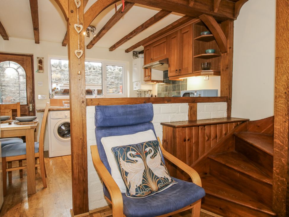 A kitchen with a table and washing machine at Marigold Cottage in Clun near Bishop's Castle