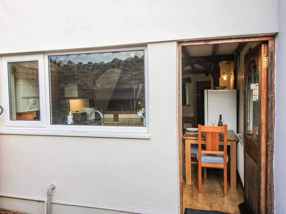 A dining room with a table and chair at Marigold Cottage Clun near Bishop's Castle