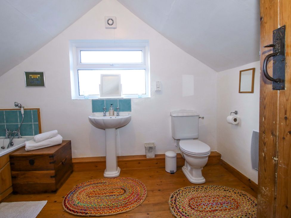 A bathroom with a sink and bathtub at Marigold Cottage in Clun near Bishop's Castle