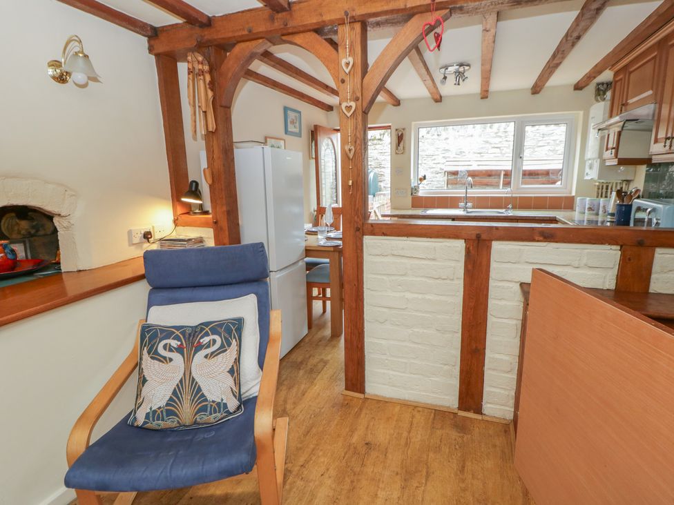 A kitchen with wooden beams and a table at Marigold Cottage in Clun near Bishop's Castle