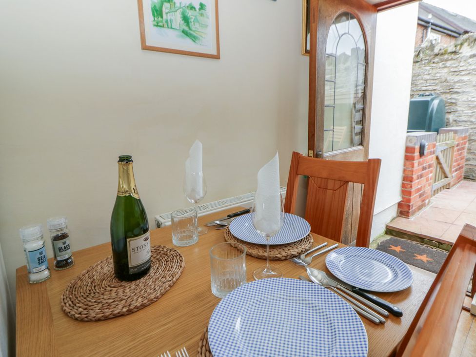 A dining room setup with a table and chairs at Marigold Cottage in Clun near Bishop's Castle