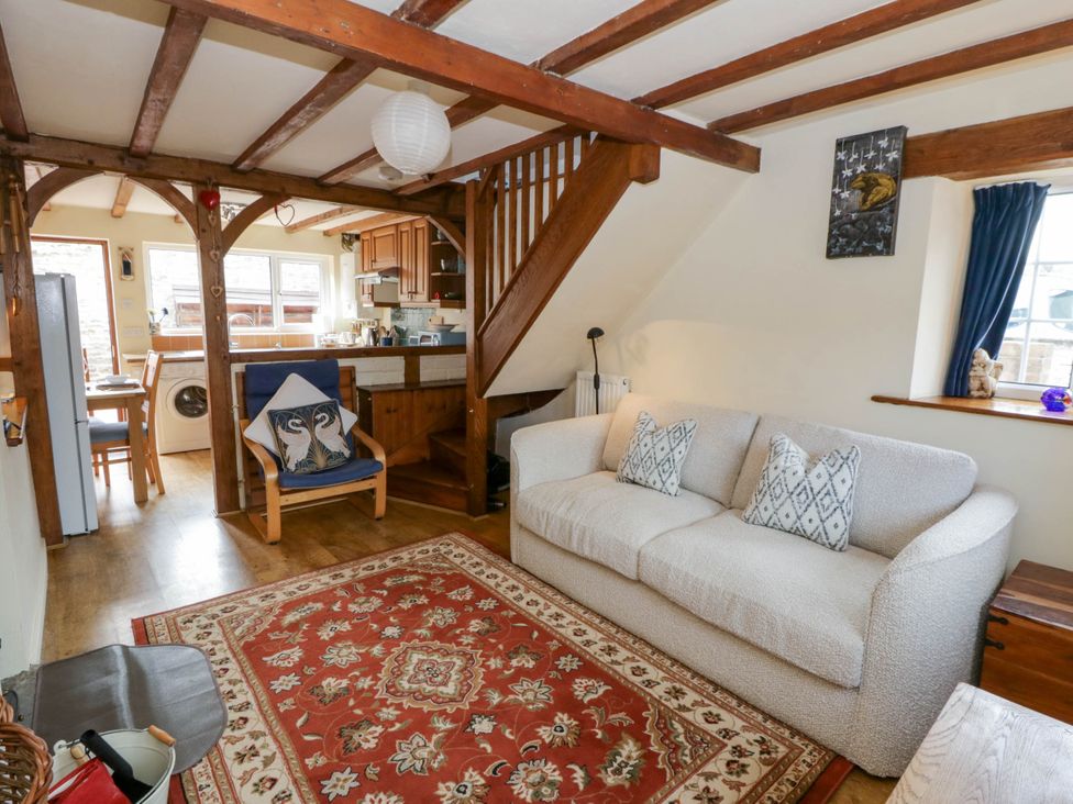 A living room with a sofa and a table at Marigold Cottage in Clun near Bishop's Castle