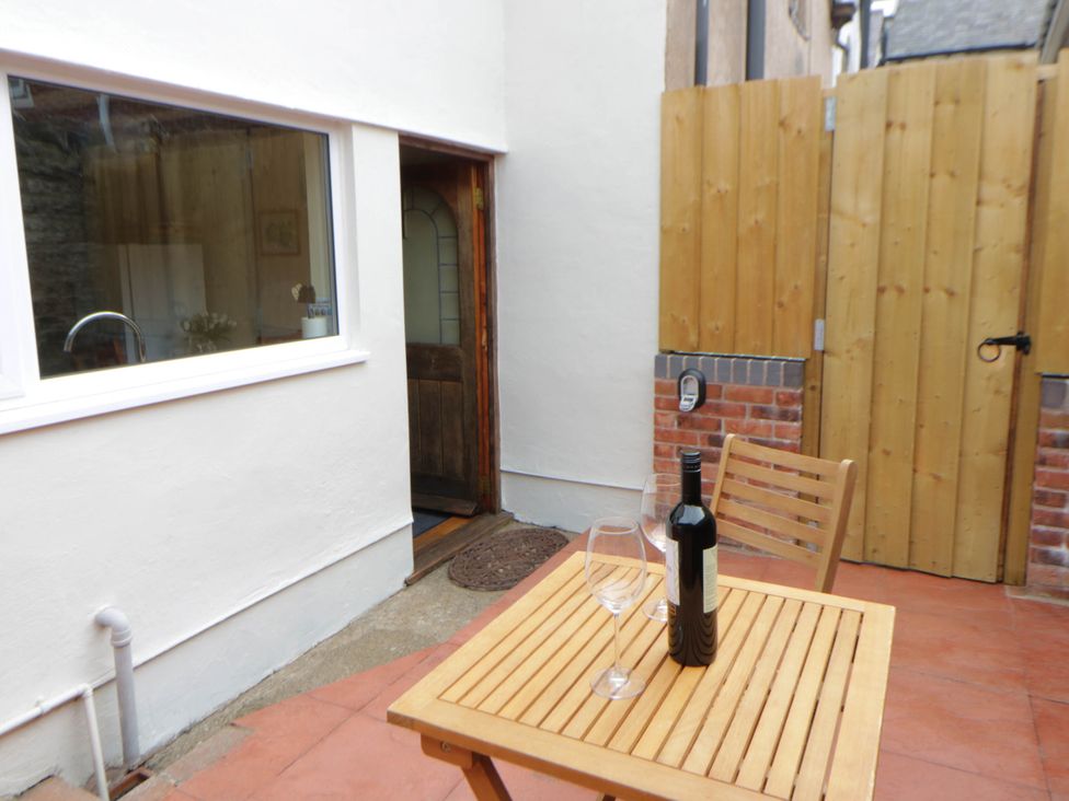 An outdoor area with a table and chairs at Marigold Cottage in Clun near Bishop's Castle