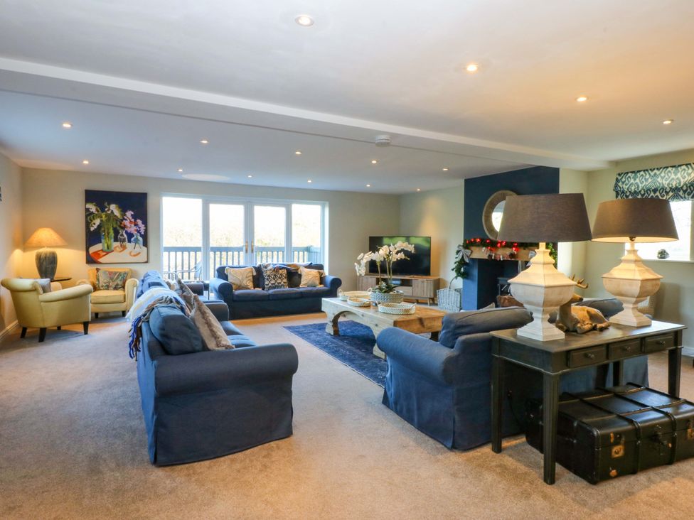 A living room with sofas and a coffee table at Nant-yr-Rhedyn in Red Wharf Bay
