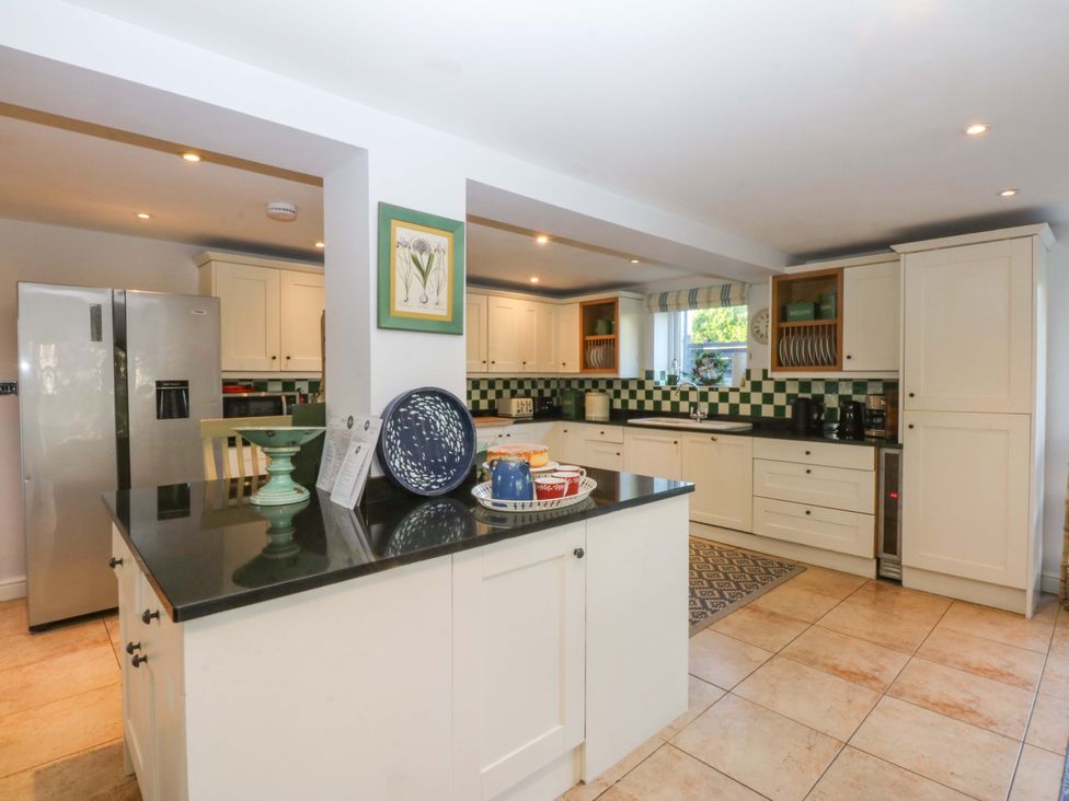 A kitchen with appliances and countertop space at Nant-yr-Rhedyn in Red Wharf Bay