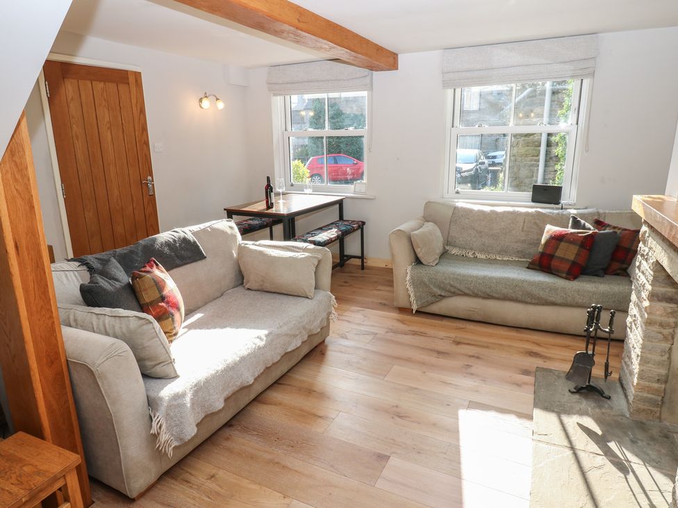 A living room with sofas and a table at Hillside View in Hawes