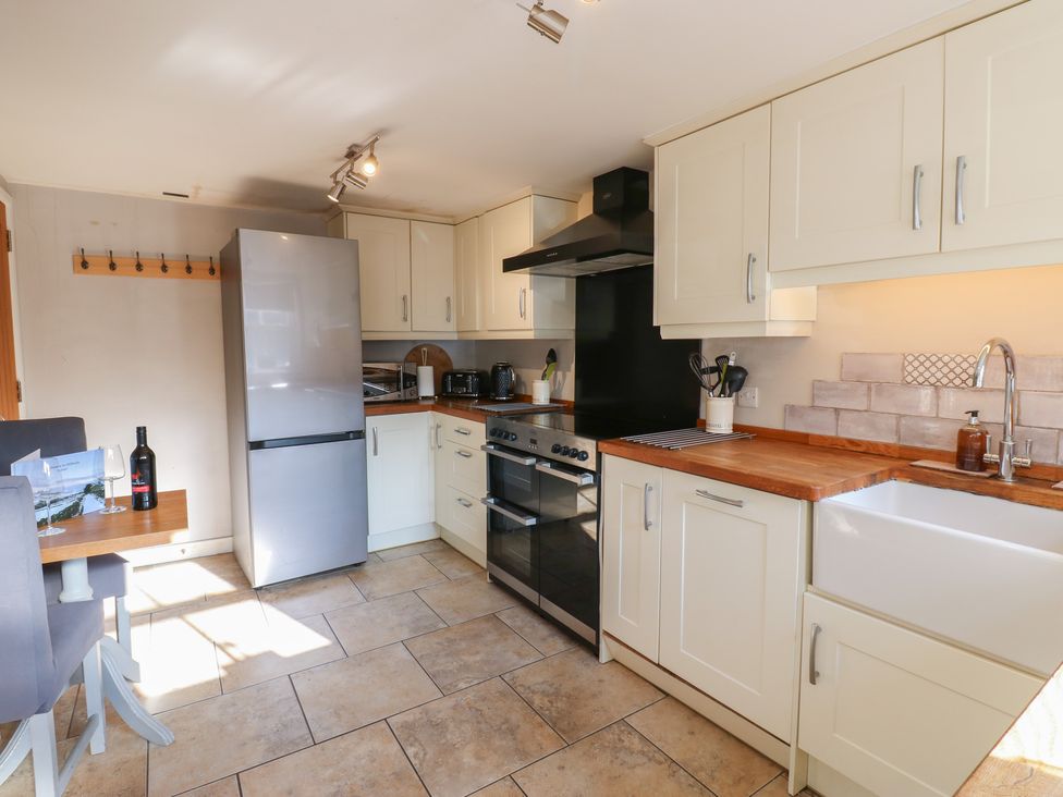 A kitchen with cabinets and appliances at Hillside View in Hawes