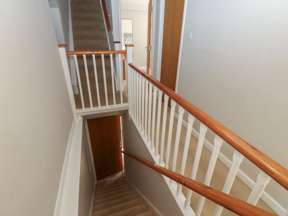 A staircase and railing in a hallway at Hillside View in Hawes