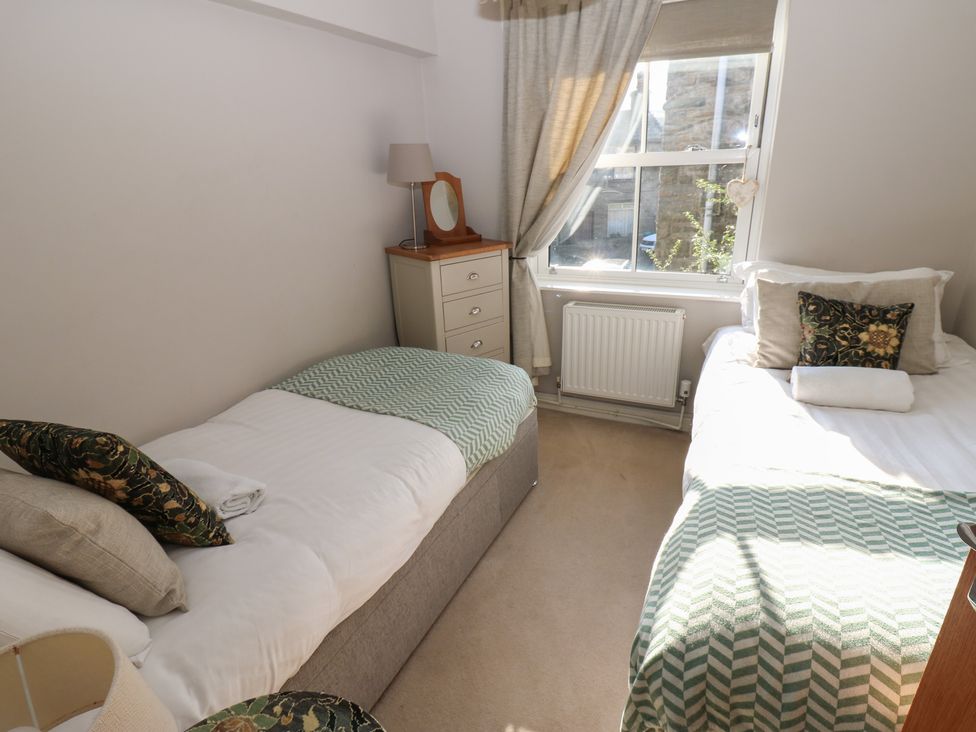 A bedroom with two beds and lighting at Hillside View in Hawes