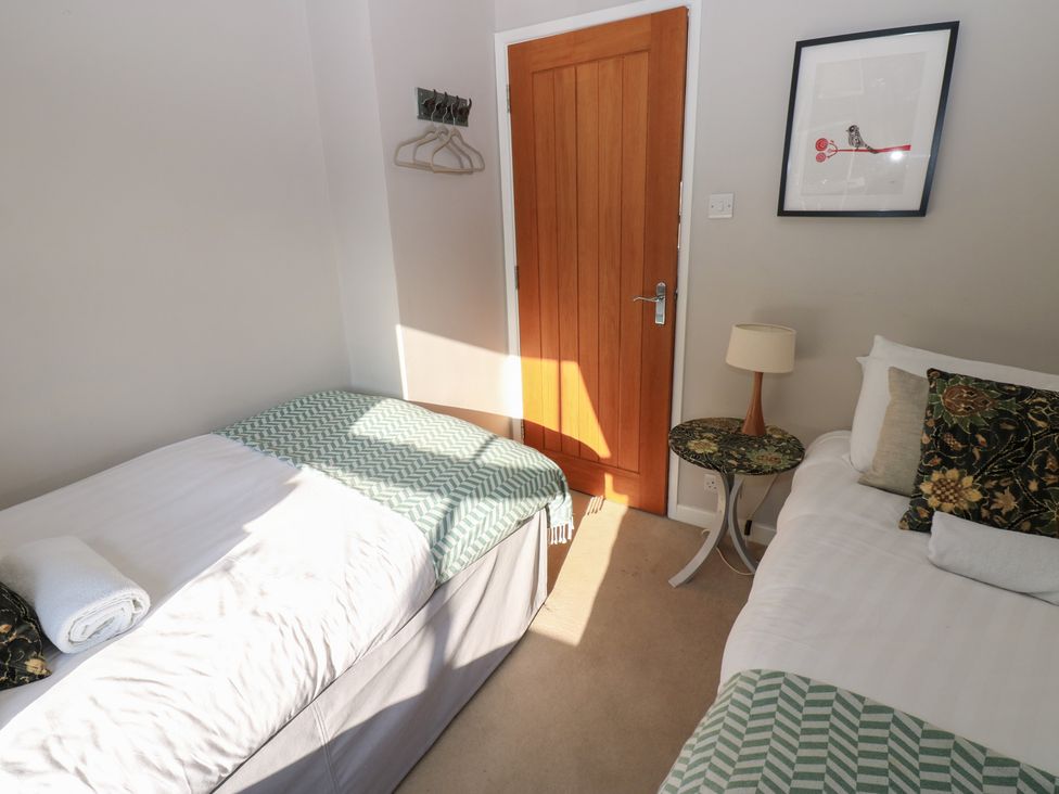 A bedroom with two beds and a window at Hillside View in Hawes