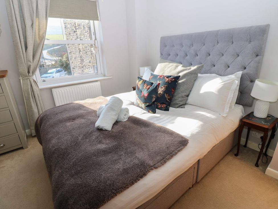 A bedroom with a bed and dresser at Hillside View in Hawes