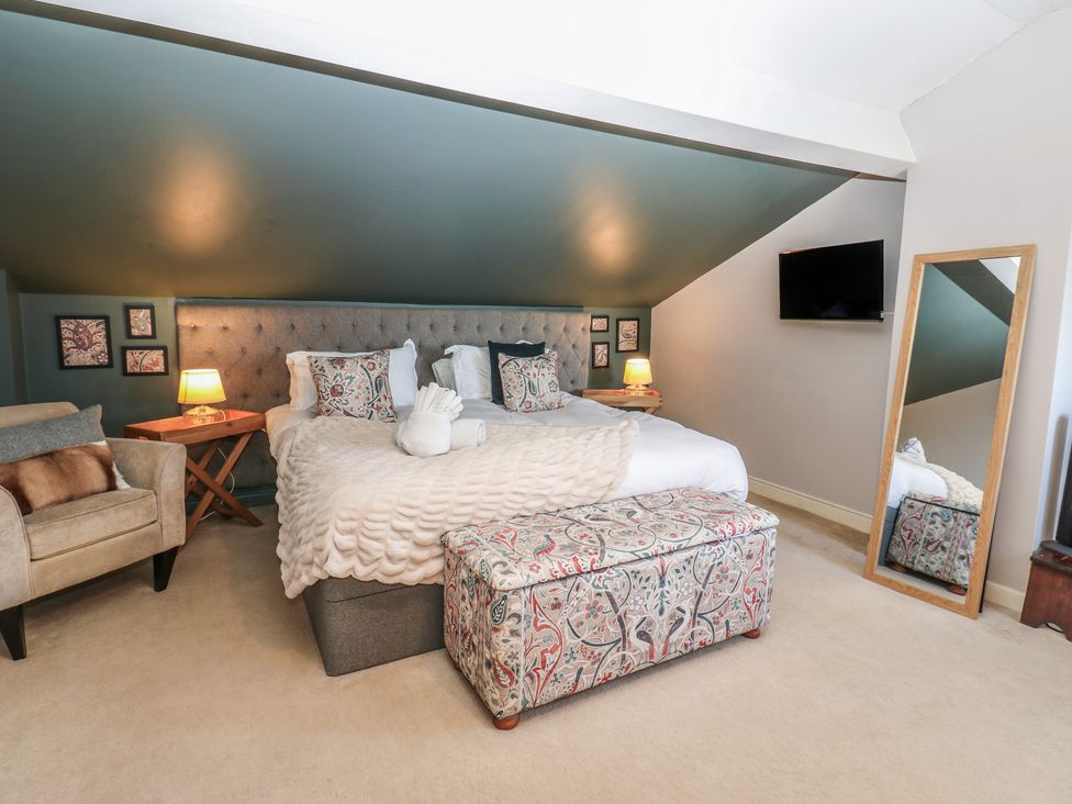 A bedroom with a bed and side table at Hillside View in Hawes