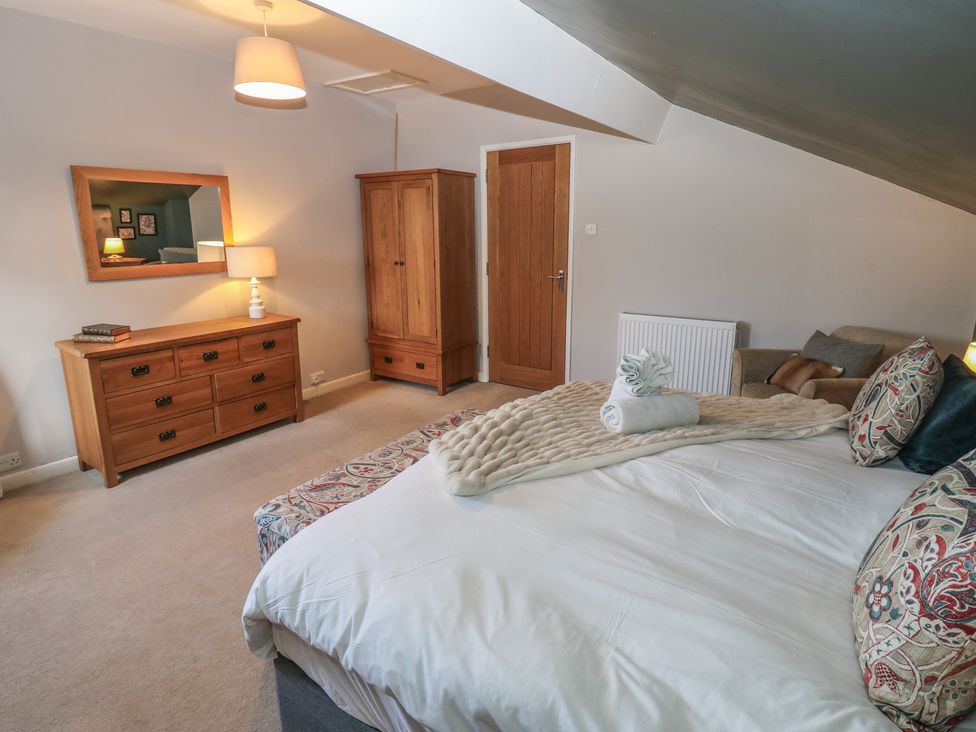 A bedroom with a bed and dresser at Hillside View in Hawes