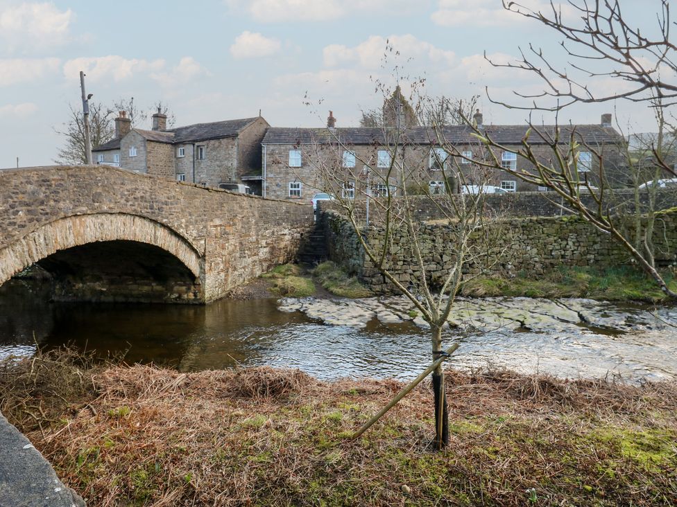 A stone bridge over a stream at Hillside View in Hawes