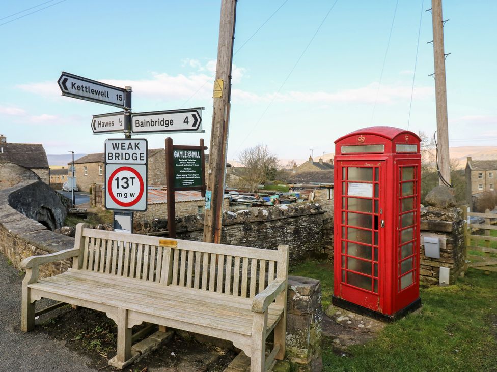 A telephone booth and signpost in Gayle, Hawes