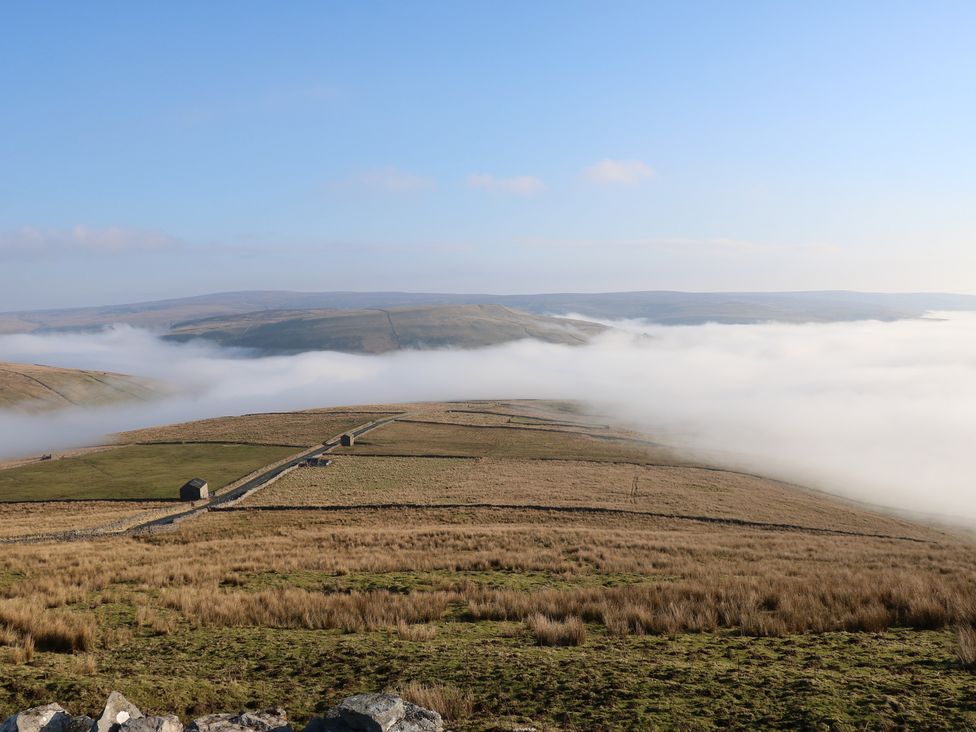 A landscape with fog rolling over hills at Hillside View, Hawes