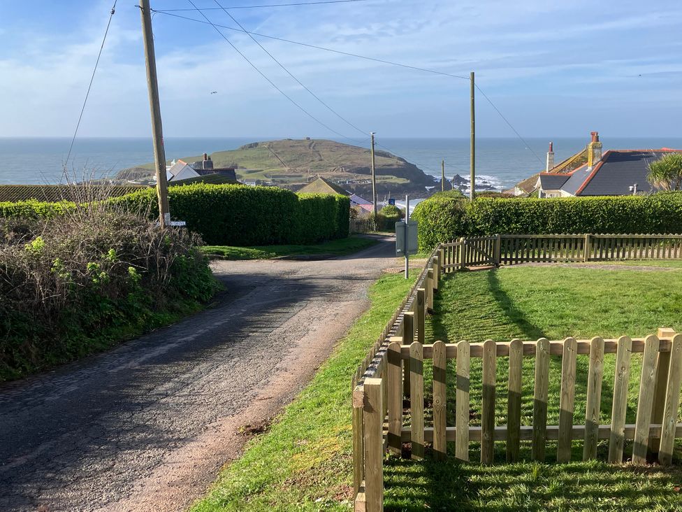A view of the ocean and houses along the road at Quarterdeck in Bigbury-on-Sea near Modbury