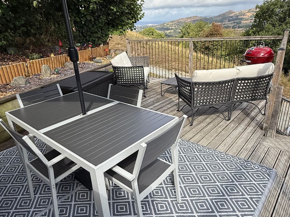 An outdoor patio with a table and chairs at Bishop's Castle Barn in Bishop's Castle