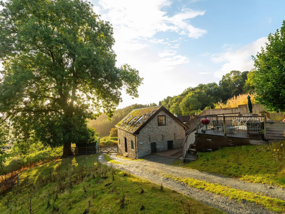 A house with a deck on a hill at Bishop's Castle Barn in Bishop's Castle