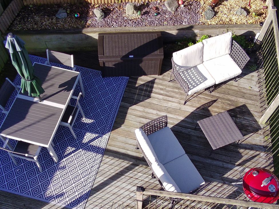 An outdoor patio with a table and chairs at Bishop's Castle Barn in Bishop's Castle