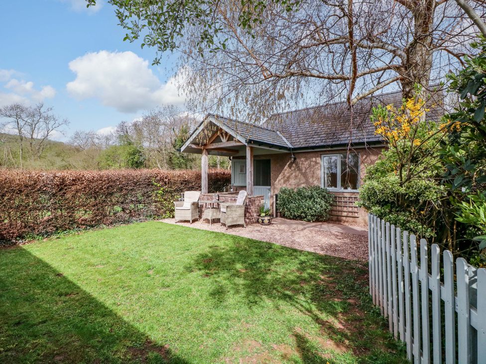 An outdoor area with seating and greenery at The Lodge, Lower Trefedw in Pandy near Abergavenny