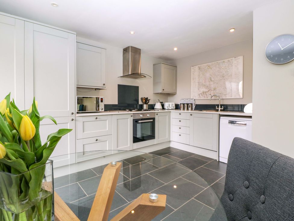 A kitchen with cabinets and appliances at The Lodge, Lower Trefedw in Pandy near Abergavenny