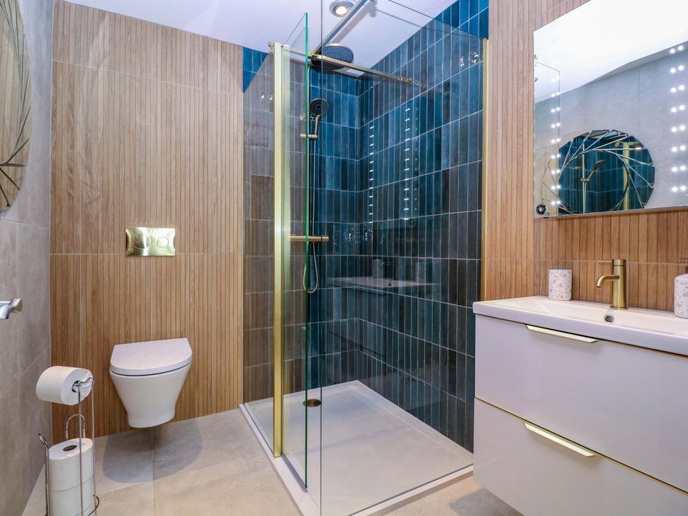 A bathroom with a shower, toilet, and sink at The Lodge, Lower Trefedw Pandy near Abergavenny