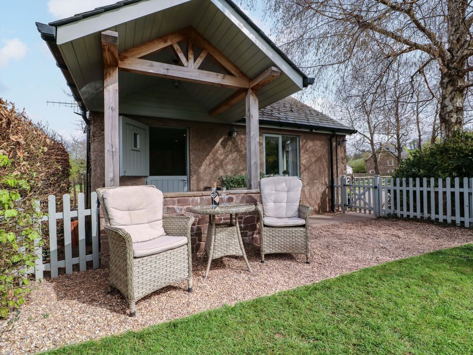 An outdoor seating area with chairs and table at The Lodge, Lower Trefedw, Pandy near Abergavenny