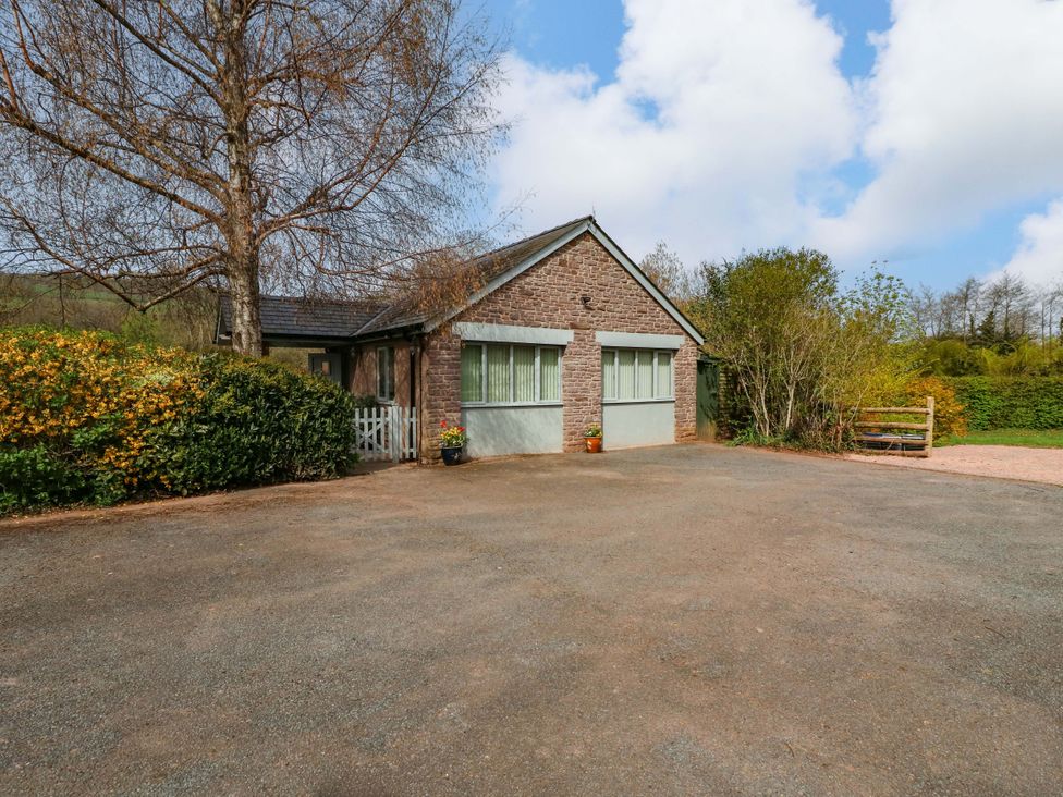 A house with a driveway and garden at The Lodge, Lower Trefedw in Pandy near Abergavenny
