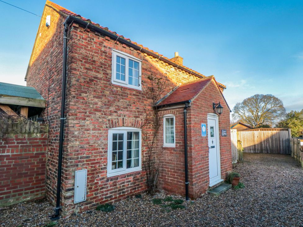 An exterior view of a brick house with front door and windows at Jasmine Cottage Dalton Near Thirsk