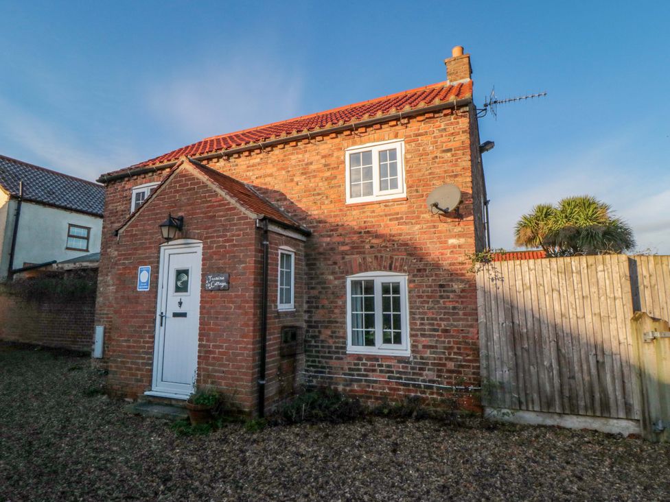 A house with windows and a door at Jasmine Cottage Dalton Near Thirsk