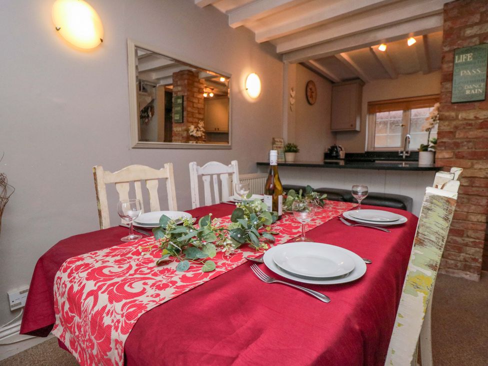 A dining table set for a meal at Jasmine Cottage in Dalton Near Thirsk