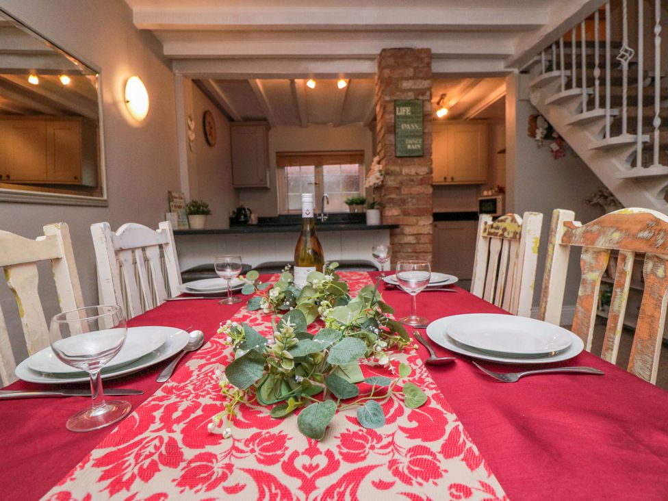 A dining room with a table set for a meal at Jasmine Cottage Dalton Near Thirsk