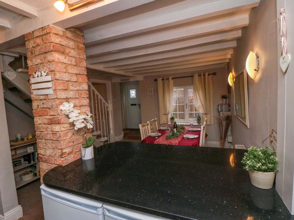 A dining room with a table and chairs at Jasmine Cottage in Dalton Near Thirsk