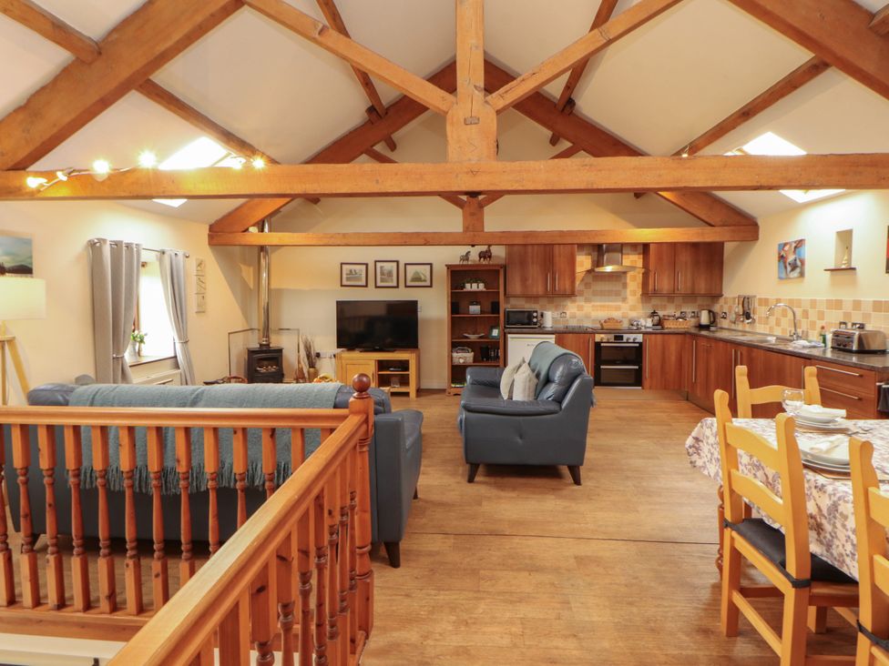 A living room with a kitchen area and seating at Hayloft Cottage Bolton Low Houses